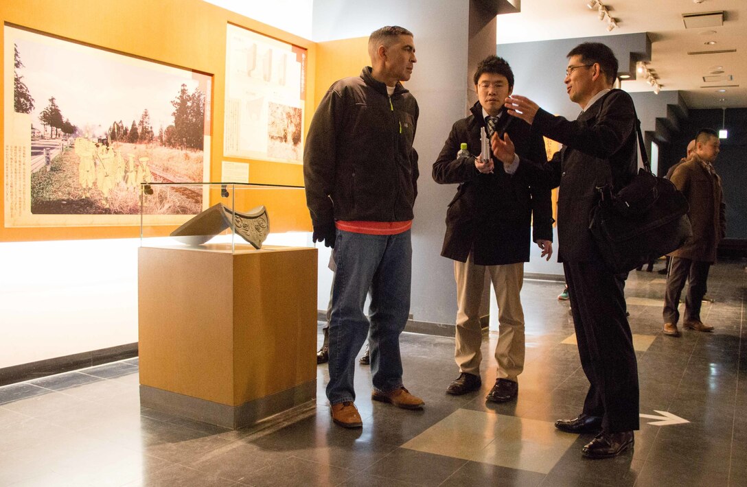 Japan Ground Self-Defense Force (JGSDF) Maj. Hisashi Matsumoto (right), reserve component section leader for the JGSDF Western Army, shares his knowledge of Kumamoto Castle in Kumamoto prefecture with U.S. Army Col. Luis Pomales (left), a San Juan, Puerto Rico, native serving as the director of the Army Reserve Engagement Team-Japan (ARET-J). The Jan. 15, 2016, tour was one of several cultural, social and military training engagements designed to enhance the bilateral partnership between ARET-J and the JGSDF Western Army's Reserve Component. (U.S. Army photo by Sgt. John L. Carkeet IV, U.S. Army Japan)