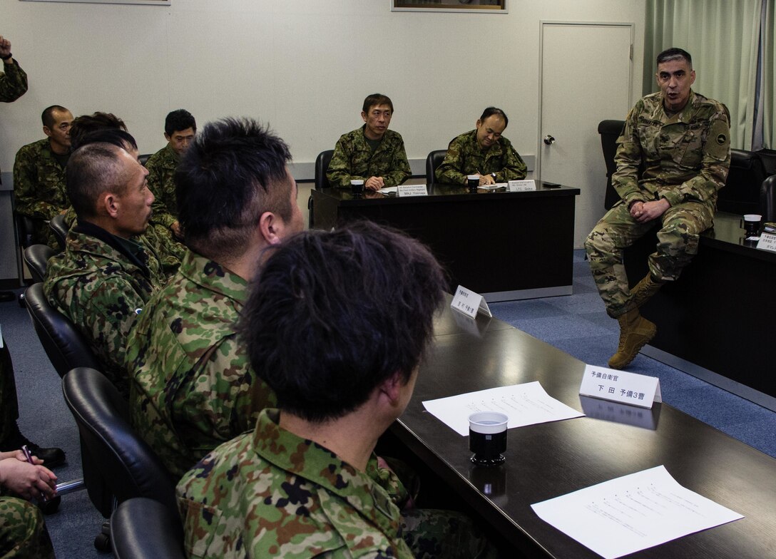 During a round table discussion conducted Jan. 16, 2016, at Camp Kenjun, Japan, U.S. Army Col. Luis Pomales (left), a San Juan, Puerto Rico, native serving as the director of the Army Reserve Engagement Team-Japan (ARET-J), discusses methods to build closer relations between Japan Ground Self Defense Force (JGSDF) Reserve Component service members and their respective civilian employers. The candid meeting was one of several social, cultural and military training events that culminated into one of the first bilateral engagements conducted exclusively by ARET-J and JGSDF Western Army Reserve Component (U.S. Army photo by Sgt. John L. Carkeet IV, U.S. Army Japan)