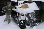 A Virginia National Guard Soldier assigned to the Staunton-based 116th Infantry Brigade Combat Team clears the snow off a Humvee Feb. 22, 2015, in Staunton to prepare for possible snow response missions after another round of heavy snow blanketed the state. 
