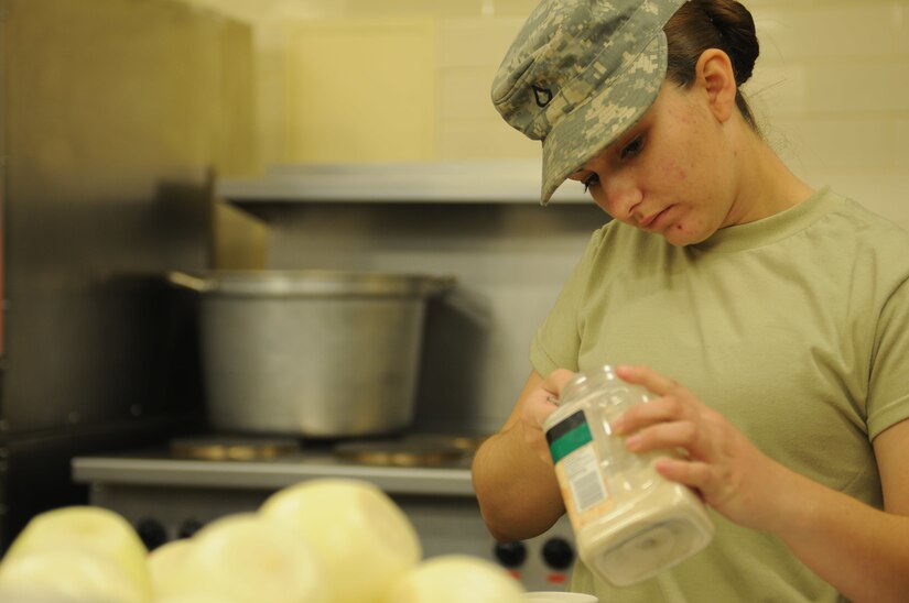 Pfc. Genephere Mata measures spices while training with the Army Reserve Culinary Arts Team.