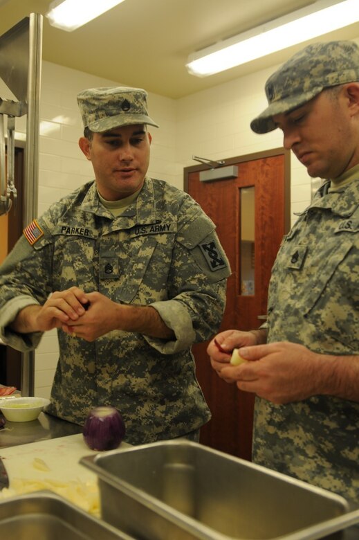 Staff Sgt. Joseph Parker, 451st Quartermaster Company and captain of the Army Reserve Culinary Arts Team, confers with Staff Sgt. Markos Mendoza, 257th Transportation Company and a member of the Army Reserve Culinary Arts Team, as they train for the 41st Annual Military Culinary Arts Competition.