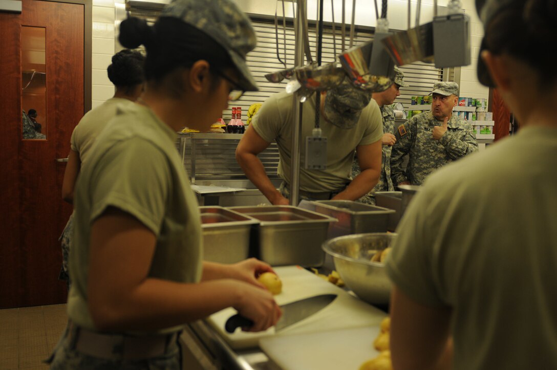 Chief Warrant Officer 2 Danny Wolf, 103rd Sustainment Command (Expeditionary) gives a thumbs up to Staff Sgt. Joseph Parker, 451st Quartermaster Company, as they observe training. The Soldiers, both members of the Army Reserve Culinary Arts Team, were in Sloan, Nevada practicing for the 41st Annual Military Culinary Arts Competition and training local Army Reserve cooks.
