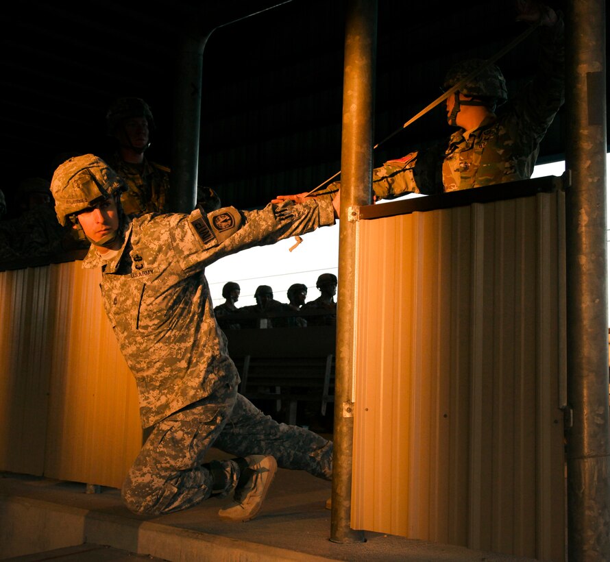 Army Sgt. 1st Class Charles Prince rehearses airborne procedures on a simulated aircraft door during a proficiency jump program at Pope Army Airfield on Fort Bragg, N.C., Jan. 16, 2016. Prince is a jumpmaster assigned to the 82nd Airborne Division’s 503rd Military Police Battalion. U.S. Army photo by Spc. Kevin Kim