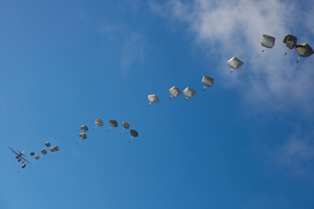 Paratroopers descend after jumping out of an Air Force C-130 aircraft during a proficiency jump program at Pope Army Airfield on Fort Bragg, N.C., Jan. 16, 2016. U.S. Army photo by Spc. Kevin Kim 