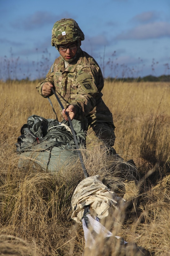 Army Pvt. Joseph Vargas recovers his parachute after a jump at Pope Army Airfield on Fort Bragg, N.C., Jan. 16, 2016. Vargas is assigned to the 82nd Airborne Division’s 2nd Battalion, 504th Infantry Regiment, 1st Brigade Combat Team. U.S. Army photo by Spc. Kevin Kim