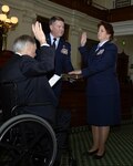 Texas Gov. Greg Abbott administers the oath of office to Brig. Gen. Dawn M. Ferrell during her promotion ceremony Jan. 15, 2016, in the Texas Capitol's Senate Chambers. Abbott appointed Ferrell as the Deputy Adjutant General - Air for the Texas Military Department's Texas Air National Guard. Ferrell is the first female to hold the rank of general officer in the TXANG.