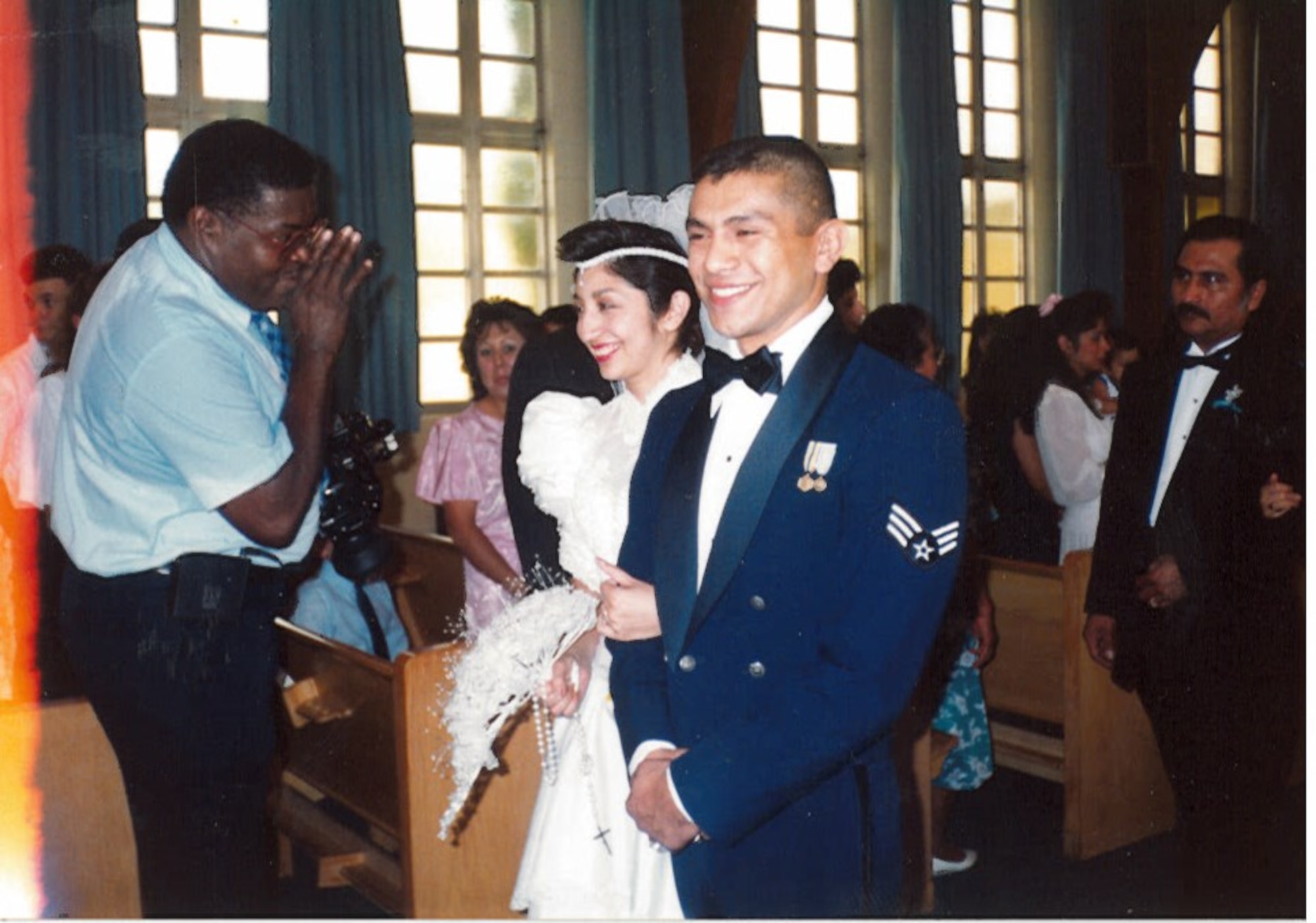 Then Senior Airman Gerardo Tapia walks down the aisle with his wife, Alice, at their wedding May 26, 1990, in San Antonio. (Courtesy photo)