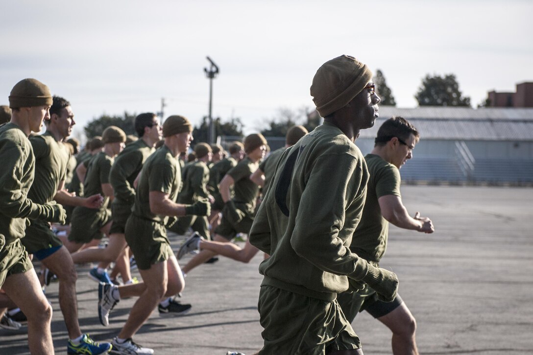 Marine Corps officer candidates perform a timed 3-mile run during their initial physical fitness test on Marine Corps Base Quantico, Va., Jan. 20, 2016. The test included the run and timed crunches and pullups. U.S. Marine Corps photo by Cpl. Patrick H. Ownes