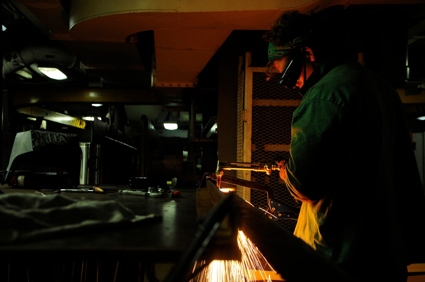 160112-N-PN275-019 DIEGO GARCIA, British Indian Ocean Territory (Jan. 12, 2016) Hull Technician Fireman Thomas Barnett, from USS Emory S. Land (AS 39) weld shop, cuts metal for a navigation chair for guided-missile submarine USS Florida (SSGN 728). Emory S. Land is a forward deployed expeditionary submarine tender on an extended deployment conducting coordinated tended moorings and afloat maintenance in the U.S. 5th and 7th Fleet areas of operations. (U.S. Navy photo by Mass Communication Specialist 3rd Class Zachary A. Kreitzer/Released)