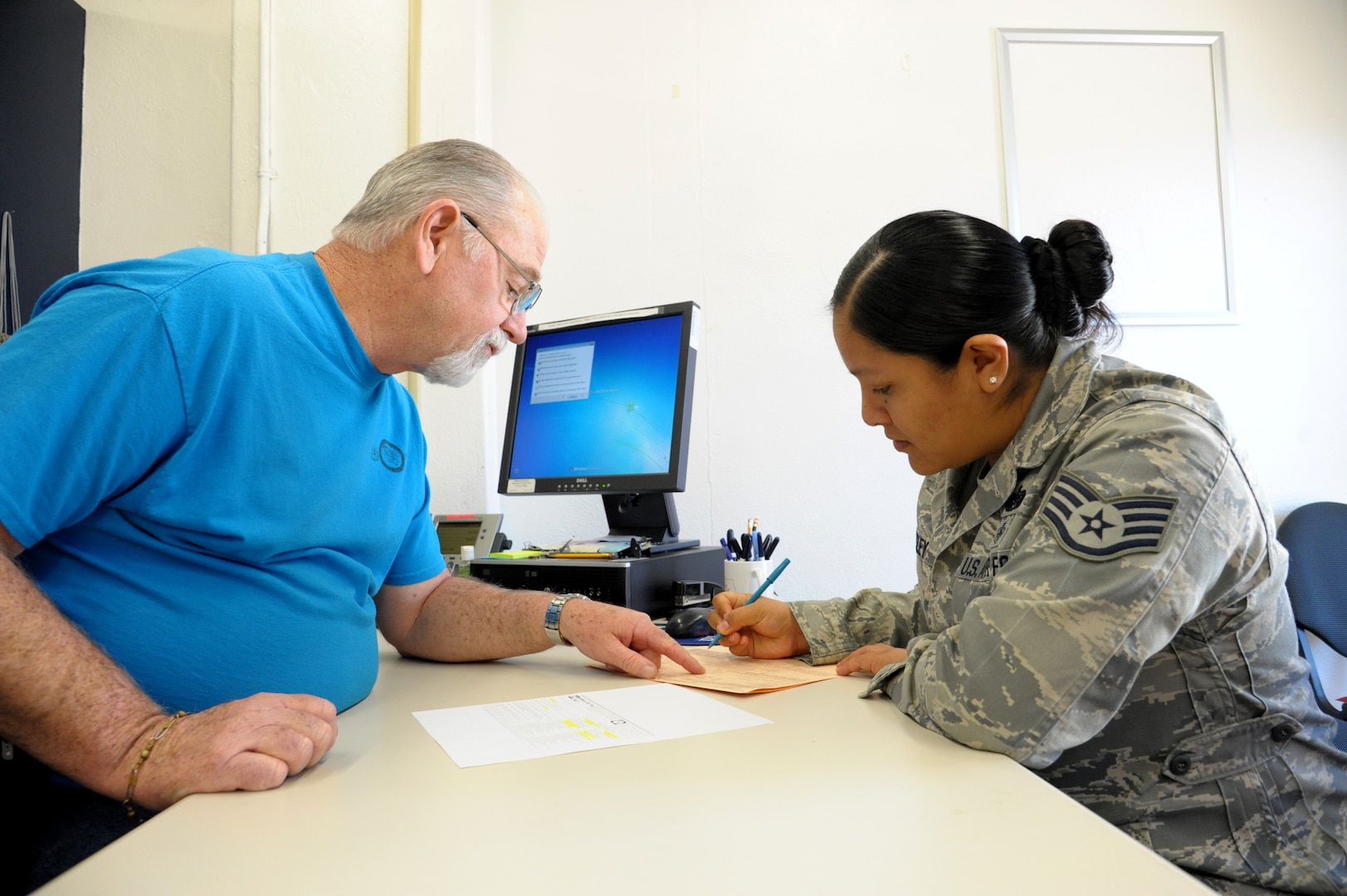 LaMarr Queen, Joint Base San Antonio-Randolph Tax Center coordinator, assists Staff Sgt. Nelly Hensley, in preparing her 2015 income tax returns, Jan. 15, 2016. The tax office will help military members, retirees and family members complete their 2015 income tax returns before the April 15 deadline.  (U.S. Air Force photo by Joel Martinez/Released)
