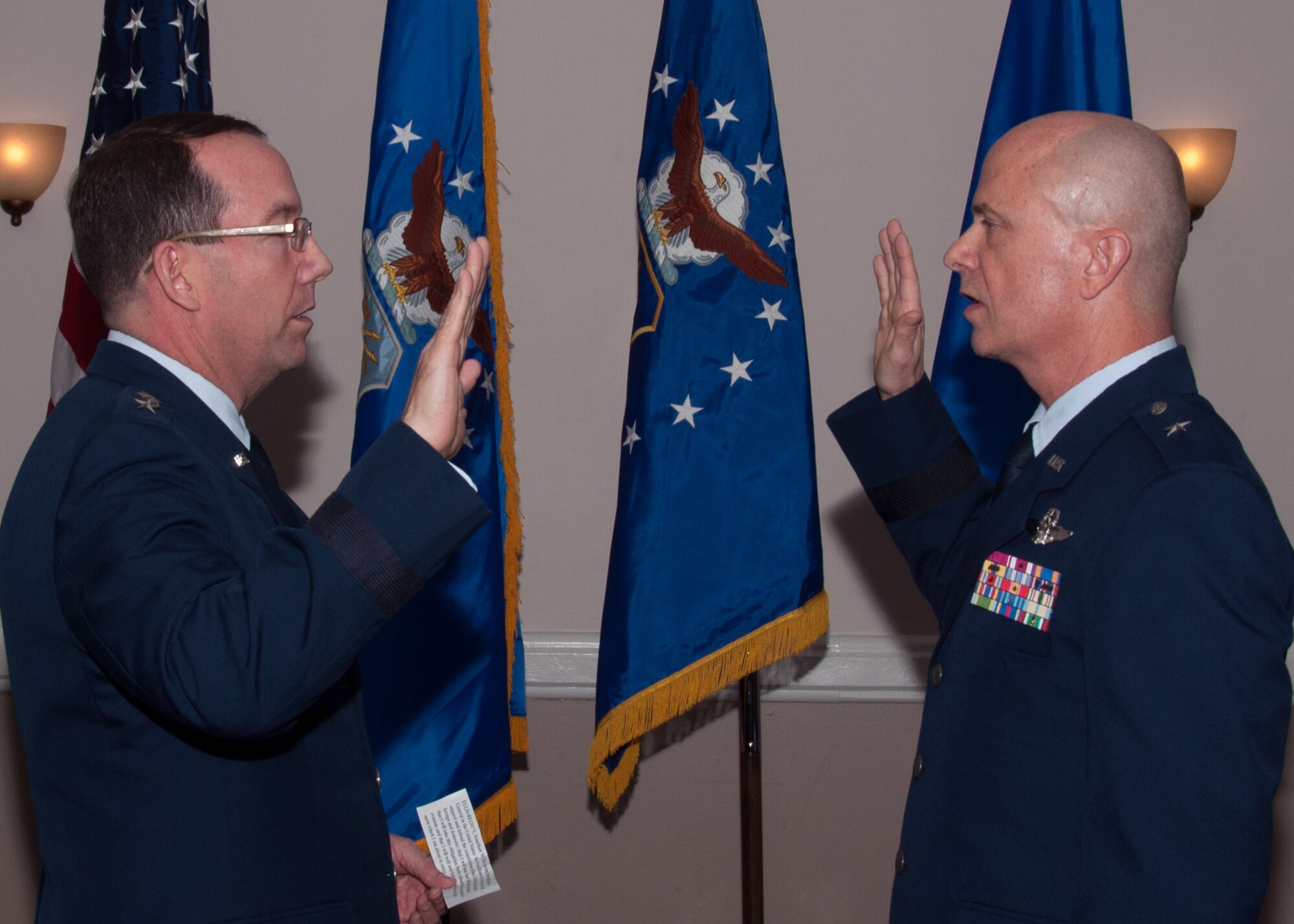 U.S. Air Force Maj. Gen. Robert Rego, Mobilization Assistant to the Commander, U.S. Strategic Command, administers the oath of office to Brig. Gen. Jonathan Ellis, Mobilization Assistant to the Director of Operations Air Force Global Strike Command. Ellis is pinning on Brigadier General during a ceremony on Jan. 15, 2016 at Barksdale Air Force Base, La. (U.S. Air Force photo by Master Sgt. Laura Siebert/Released)