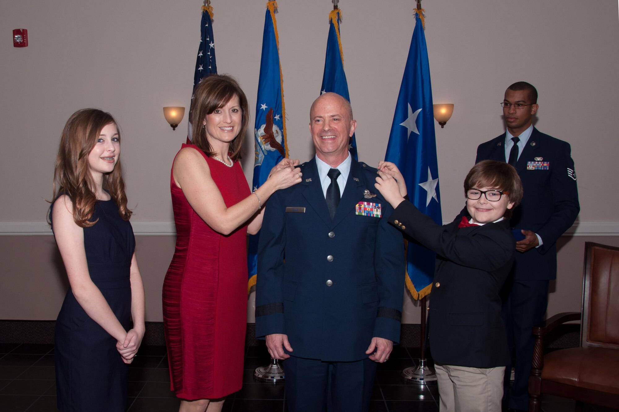 U.S. Air Force Brig. Gen. Jonathan Ellis is "pinned" by his wife, Traci, and son, Max, while his daughter, Molly, looks on, Jan. 15, 2016, Barksdale Air Force Base, La. Ellis is a B-52 pilot and the former commander of the 307th Bomb Wing now serving as Mobilization Assistant to the Director of Operations Air Force Global Strike Command. (U.S. Air Force photo by Master Sgt. Laura Siebert/Released)