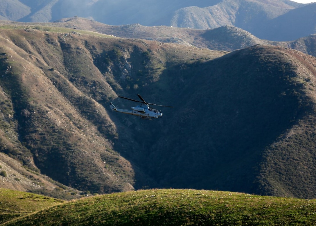 Joint Tactical Attack Controllers conduct training by directing an AH-1W Super Cobra to targets along the hill sides of Marine Corps Base Camp Pendleton, Calif., Jan. 13, 2016. The Super Cobra uses its three barrel 20mm cannon and launches various rackets to hit its mark with precision. The Marines are with 1st Air Naval Gunfire Liaison Company, I Marine Expeditionary Force. (U.S. Marine Corps photo by Lance Cpl. Timothy Valero/ Released)