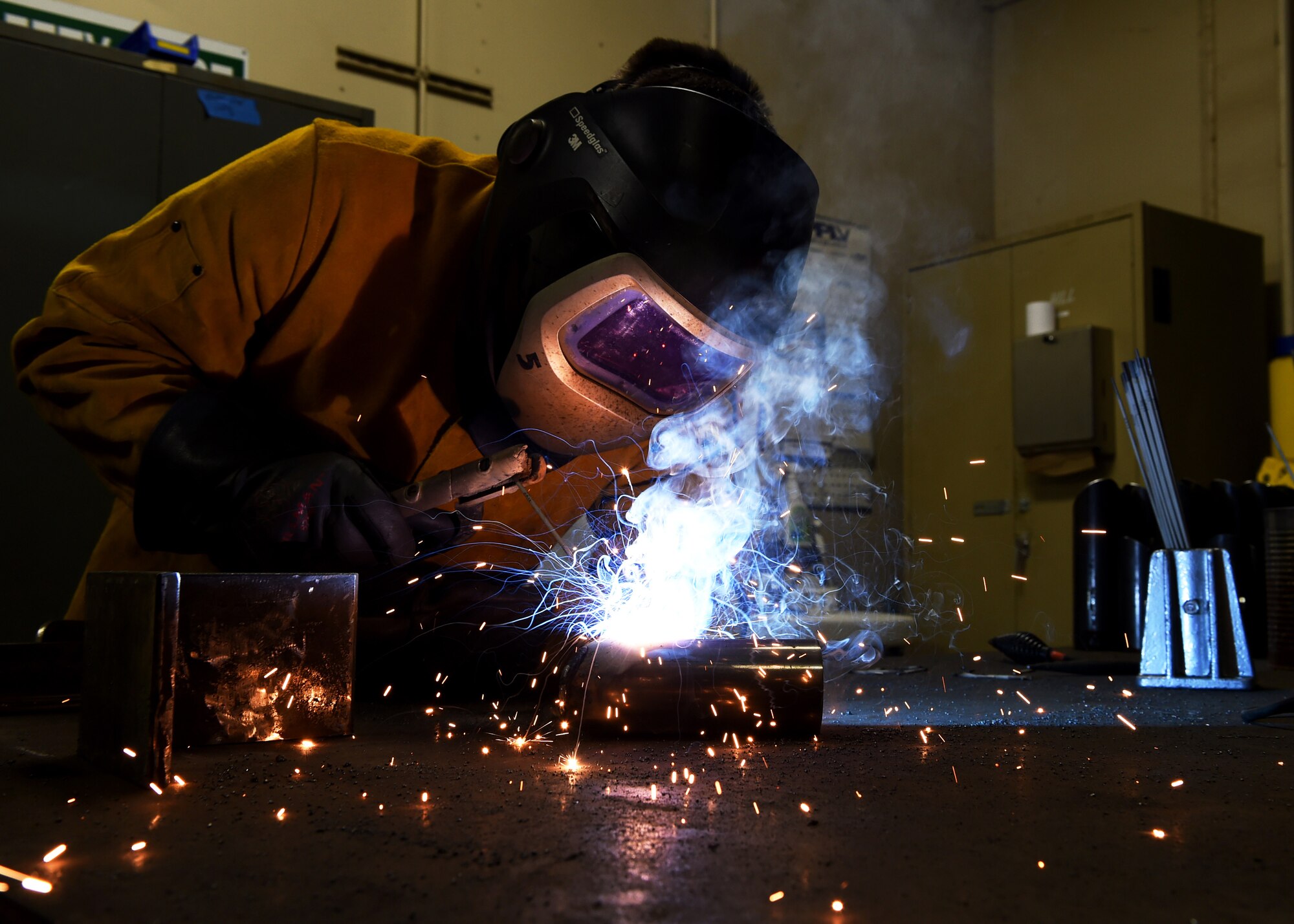 U.S. Air Force Airman 1st Class Tyler Steenbeke-Notaro, 97th Civil Engineer Squadron structural apprentice, welds L-brackets together to be mounted on the base perimeter wall near housing, Jan. 15 at Altus Air Force Base, Okla. Members of the 97th Civil Engineer Squadron and the 97th Security Forces Squadron teamed up to improve base security by installing additional force protection measures along 3,200 feet of the base’s perimeter fence.