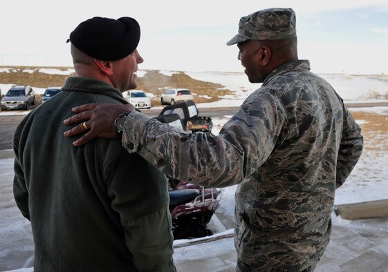 Master Sgt. Tyler Conner, 28th Security Forces Squadron NCO in charge of security forces training, left, talks with Maj. Gen. Richard Clark, Eighth Air Force commander, about the all-terrain vehicles the security forces squadron use to access off-road locations at Ellsworth Air Force Base, S.D., Jan. 19, 2016. Clark visited with various squadrons, learning their roles in the base’s mission, and getting to know the bomber Airmen of the 28th Bomb Wing.
