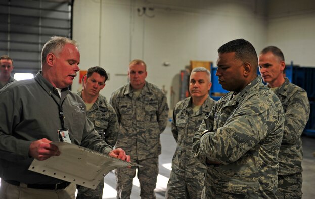 Maj. Gen. Richard Clark, Eighth Air Force commander, listens to a presentation about the cold spray system at Ellsworth Air Force Base, S.D., Jan. 19, 2016. Ellsworth is one of the first bases to implement the cold spray system, which has the potential to save the Air Force millions of dollars when repairing damages.