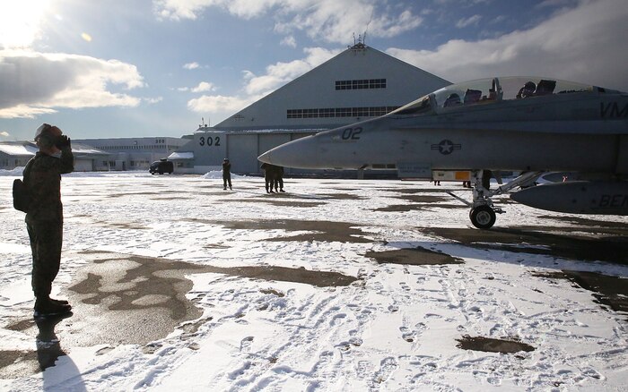 A maintainer with Marine All-Weather Fighter Attack Squadron (VMFA) 224 salutes the pilots inside an F/A-18D Hornet before taking off at Chitose Air Base in Hokkaido, Japan, Jan. 14, 2016. VMFA (AW)-224, homebased at MCAS Beaufort, S.C., is temporarily based in Iwakuni on a unit deployment program and deployed to Northern Japan to participate in the Chitose Aviation Training Relocation Exercise Jan. 12-22. During the exercise, the squadron conducted dissimilar air combat training with and against the Japan Air Self-Defense Force to further support combined interoperability and Pacific theater security cooperation.