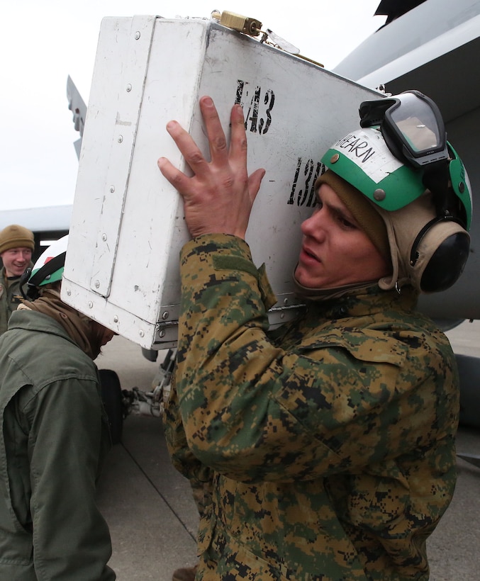Lance Cpl. Dylan Ahearn, a fixed-wing aviation safety equipment mechanic with Marine All-Weather Fighter Attack Squadron (VMFA) 224, carries a toolbox at Chitose Air Base apron in Hokkaido, Japan, Jan. 13, 2016. VMFA (AW)-224, homebased at Marine Corps Air Station Beaufort, S.C., is temporarily based in Iwakuni on a unit deployment program and deployed to Northern Japan to participate in the Chitose Aviation Training Relocation Exercise Jan. 12-22. During the exercise, the squadron conducted dissimilar air combat training with and against the Japan Air Self-Defense Force to further support combined interoperability and Pacific theater security cooperation.