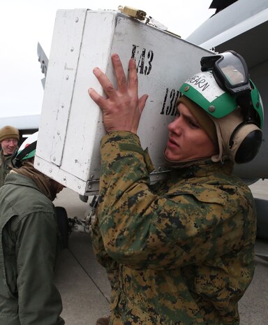 Lance Cpl. Dylan Ahearn, a fixed-wing aviation safety equipment mechanic with Marine All-Weather Fighter Attack Squadron (VMFA) 224, carries a toolbox at Chitose Air Base apron in Hokkaido, Japan, Jan. 13, 2016. VMFA (AW)-224, homebased at Marine Corps Air Station Beaufort, S.C., is temporarily based in Iwakuni on a unit deployment program and deployed to Northern Japan to participate in the Chitose Aviation Training Relocation Exercise Jan. 12-22. During the exercise, the squadron conducted dissimilar air combat training with and against the Japan Air Self-Defense Force to further support combined interoperability and Pacific theater security cooperation.