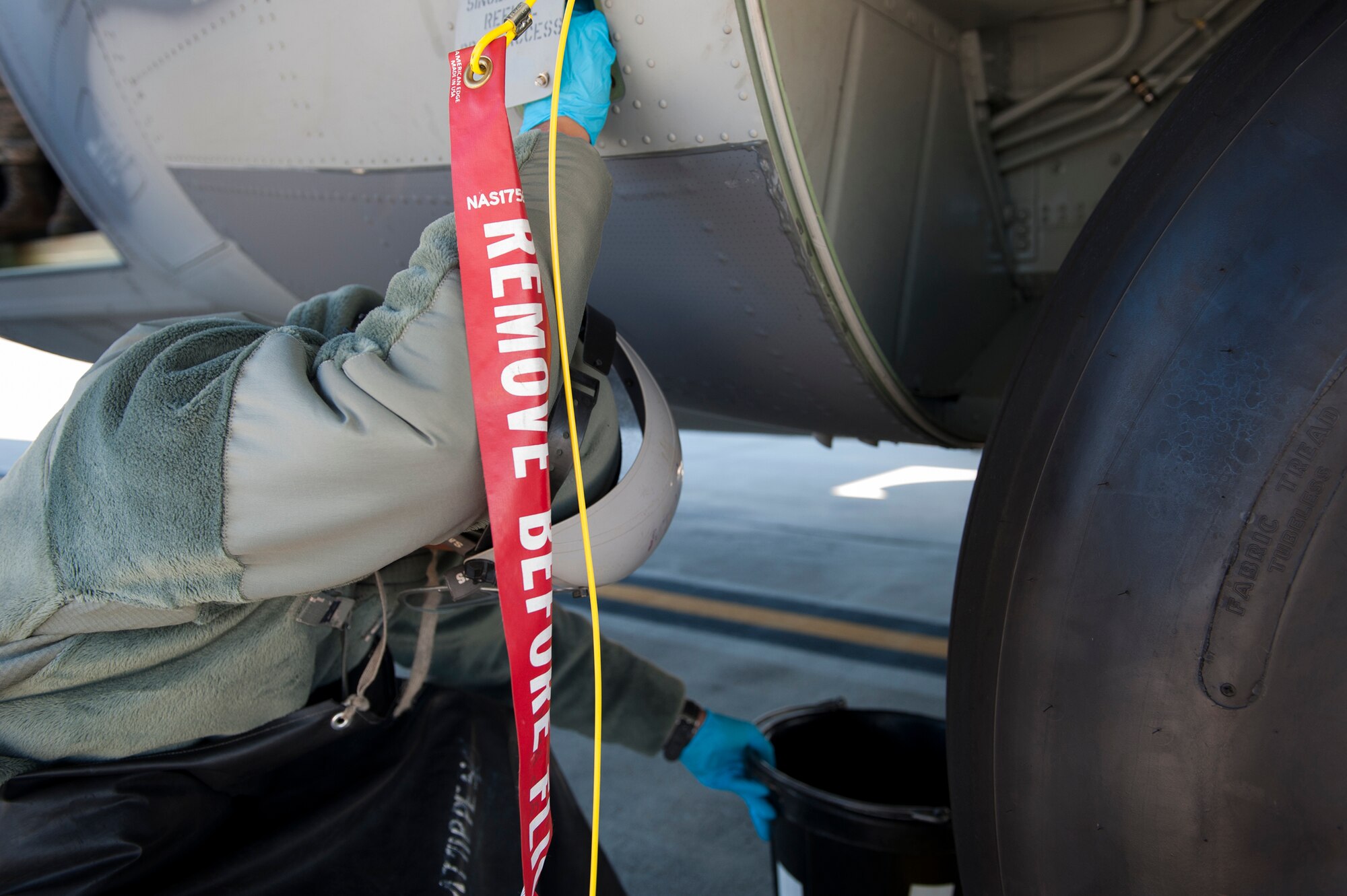U.S. Air Force Airman 1st Class Darrius Drew, 71st Aircraft Maintenance Unit airlift special missions aircraft maintenance apprentice, drains the residual fuel out of the refuel manifold, Jan. 20, 2016, at Moody Air Force Base, Ga. Drew wore personal protective equipment to shield himself in the event the gas splashed out. (U.S. Air Force photo by Airman 1st Class Kathleen D. Bryant/Released)
