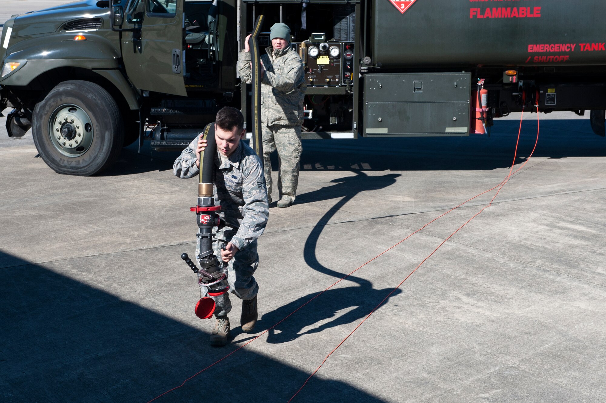 U.S. Air Force Senior Airman Phillip Switzer, 23d Logistics Readiness Squadron fuels facilities technician, front, and Staff Sgt. James Mondy, 71st Aircraft Maintenance Unit crew chief, prepare a refueling hose, Jan. 20, 2016, at Moody Air Force Base, Ga. The refueling process for an HC-130J Combat King II takes approximately ten minutes and adds 20,000 pounds of fuel to the aircraft. (U.S. Air Force photo by Airman 1st Class Kathleen D. Bryant/Released)

