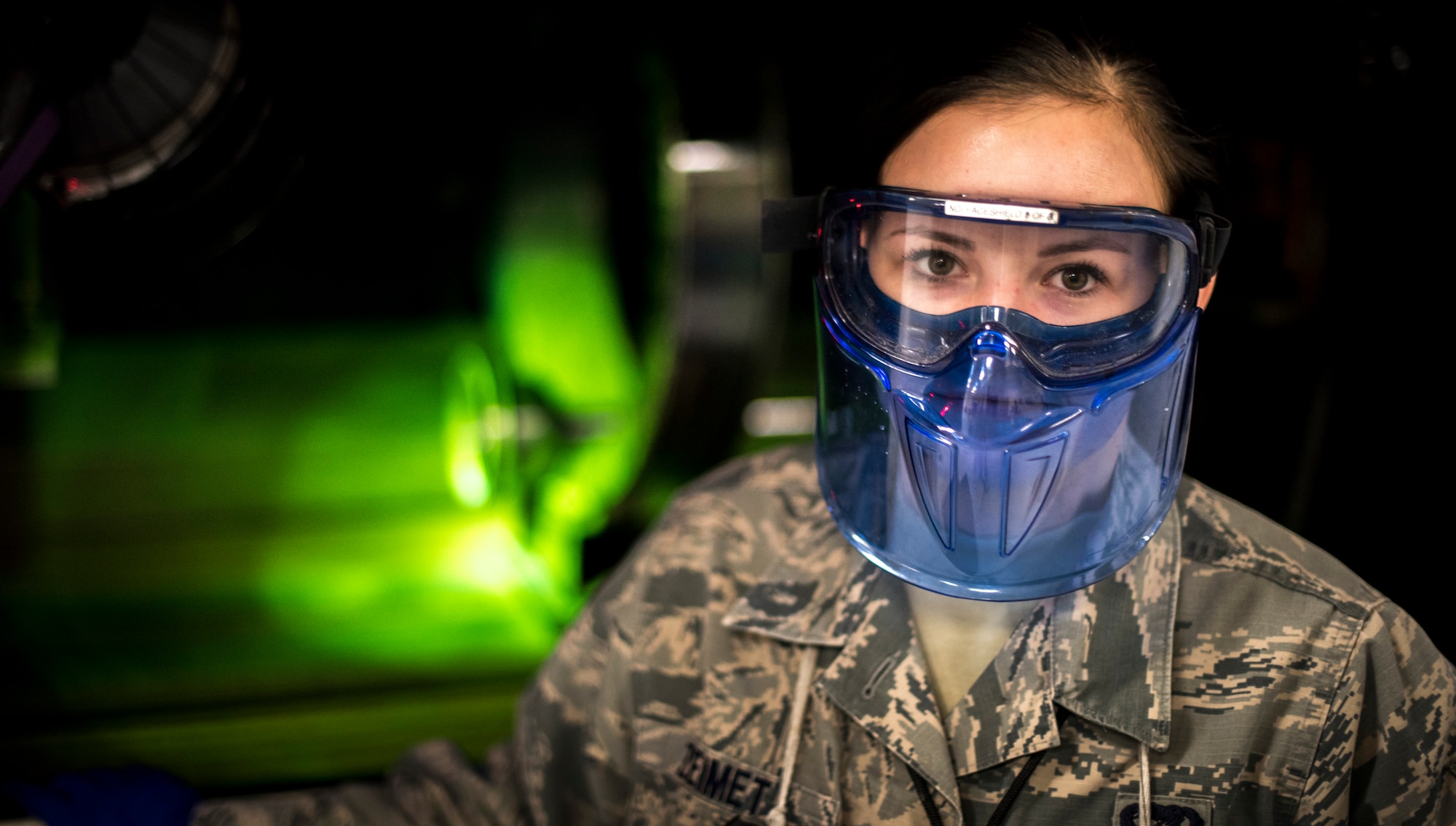 Senior Airman Violette Zeimet, 366th Equipment Maintenance Squadron non-destructive inspections journeyman, poses for a photo in front of one of the machines, Jan. 15, 2016, at Mountain Home Air Force Base, Idaho.  With different types of materials coming into the shop, NDI personnel must determine what test method to use and prepare fluids and parts for inspection.(U.S. Air Force photo by Senior Airman Jeremy L. Mosier/Released)