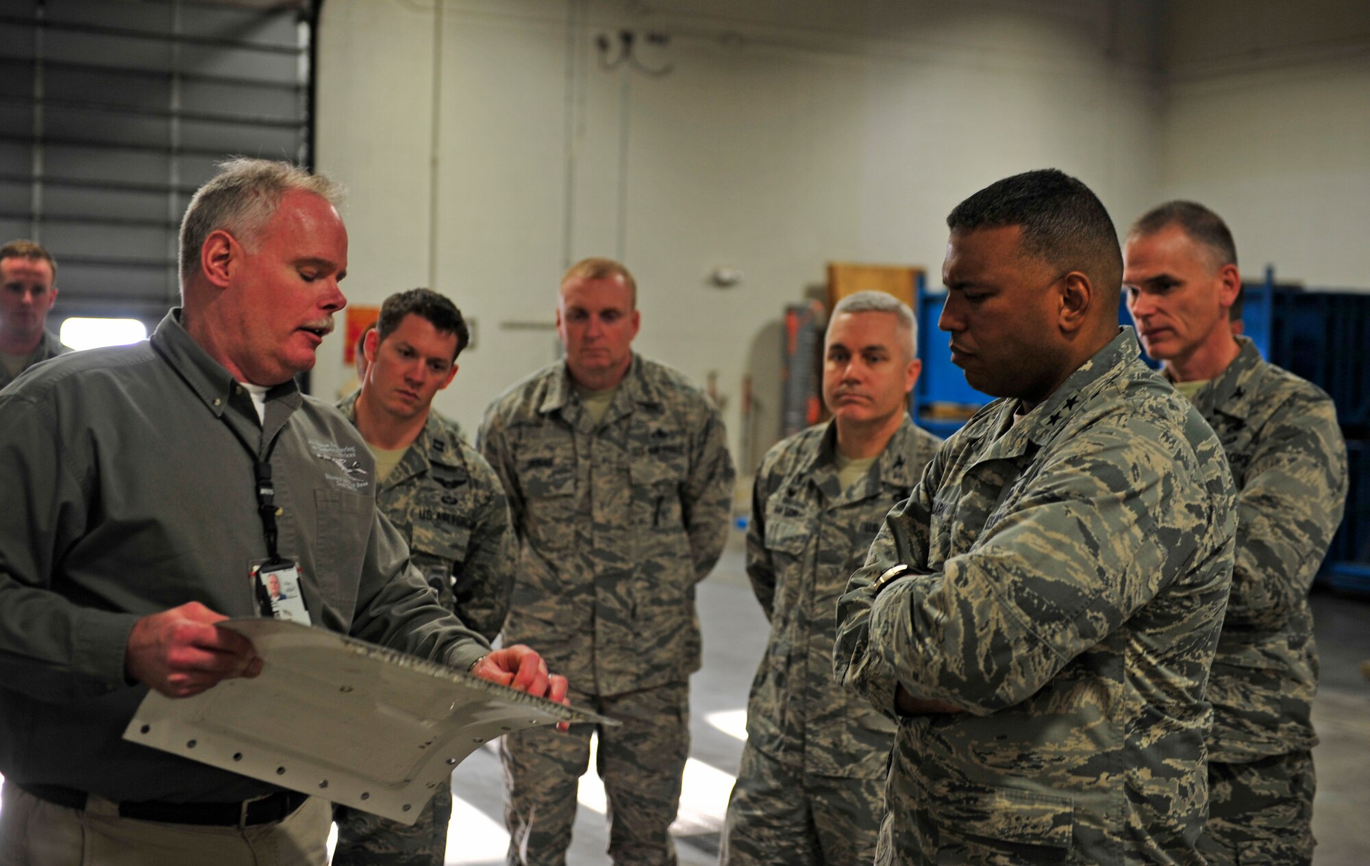 Maj. Gen. Richard Clark, Eighth Air Force commander, listens to a presentation about the cold spray system at Ellsworth Air Force Base, S.D., Jan. 19, 2016. Ellsworth is one of the first bases to implement the cold spray system, which has the potential to save the Air Force millions of dollars when repairing damages. (U.S. Air Force photo by Airman 1st Class James L. Miller/Released)