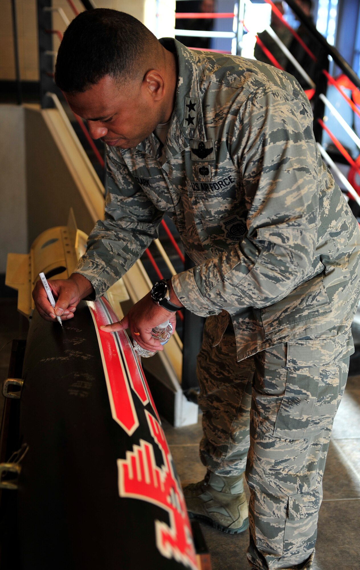 Maj. Gen. Richard Clark, Eighth Air Force commander, signs an inert MK-62 500-pound Quick Strike Mine at Ellsworth Air Force Base, S.D., Jan. 19, 2016. The general signed the munition after receiving a tour of the 34th Bomb Squadron, which has been renovated since his last time at Ellsworth. (U.S. Air Force photo by Airman 1st Class James L. Miller/Released)