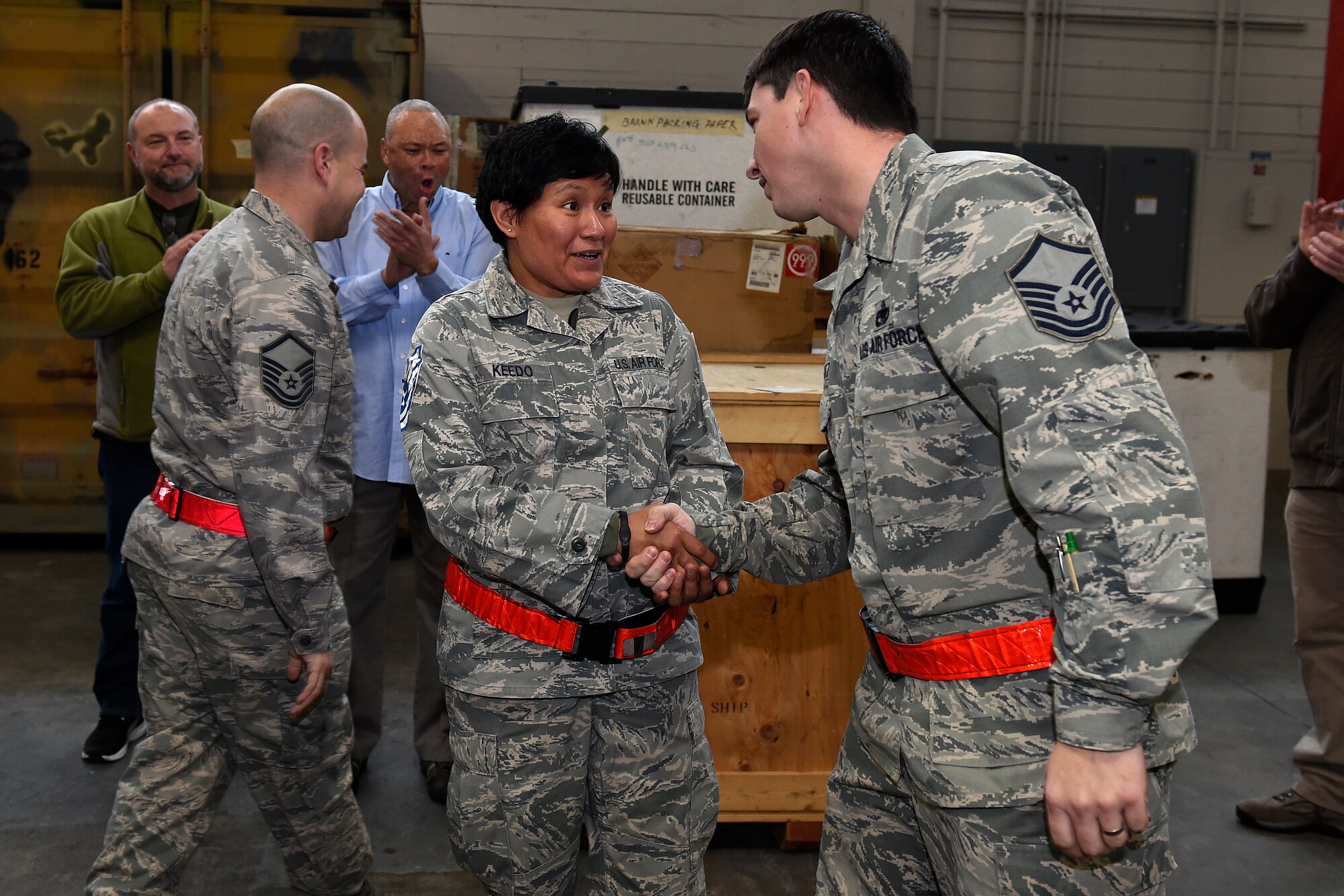 Staff Sgt. Lea Keedo, (center) 62nd Aerial Port Squadron, is notified of her selected for promotion to technical sergeant through the Stripes for Exceptional Performers Program Jan. 19, 2016 at Joint Base Lewis-McChord, Wash.  Keedo received one of the 10 possible selections for the STEP program throughout all of Air Mobility Command. (U.S. Air Force photo by Tech. Sgt. Tim Chacon)