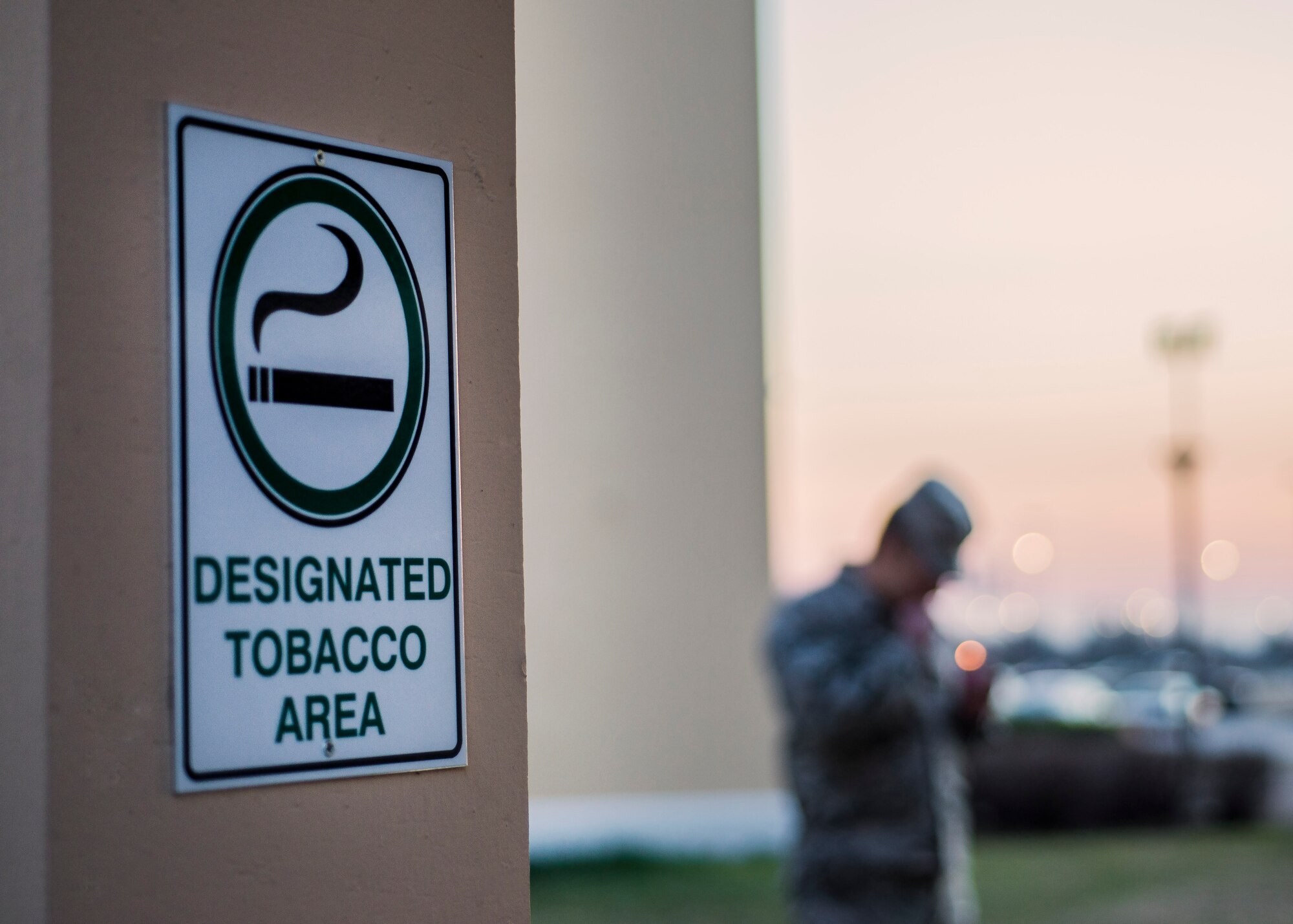 Designated Tobacco Areas are represented by signs displaying it’s an area where individuals can use tobacco products. All Department of Defense personnel and family members are required to use these areas when on an installation. (U.S. Air Force photo by Airman 1st Class Cory W. Bush/Released)