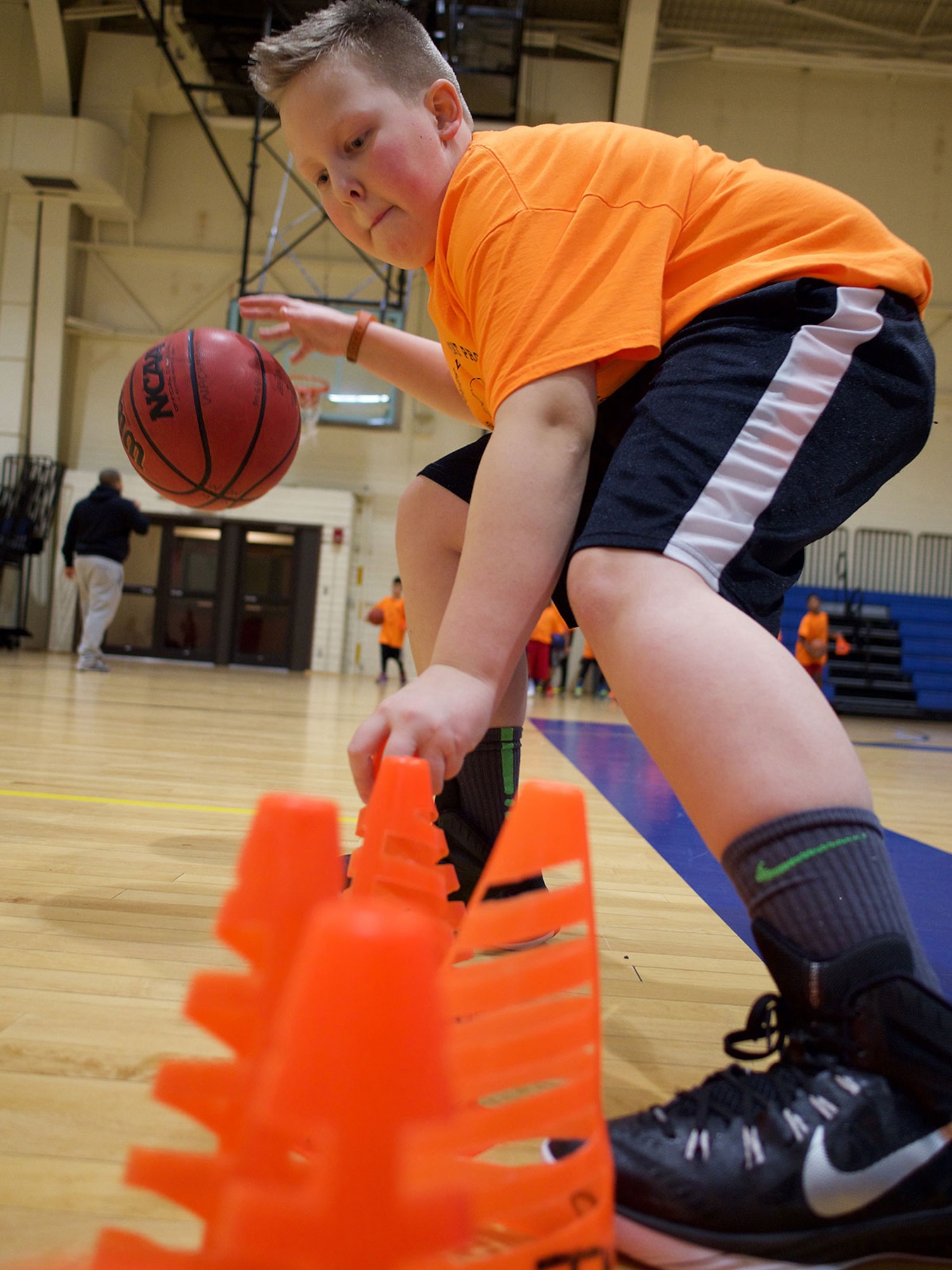 Garin Grains, a Youth Development Program athlete, carries out a drill Jan. 7 at the Elmendorf Fitness Center. Garin and other TYDP participants focus on basketball fundamentals courtside while working to get good marks in school. (U.S. Air Force photo by David Bedard)