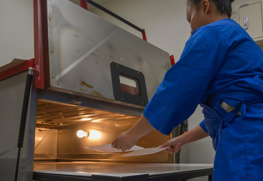 Tech. Sgt. Joy Victoria, 374th Surgical Operations Squadron orthotics NCO in charge, places polypropylene plastic in an oven at Yokota Air Base, Japan, Jan. 20, 2016. The plastic is molded to a person’s foot and used for shoe inserts. (U.S. Air Force photo by Senior Airman David Owsianka/Released)