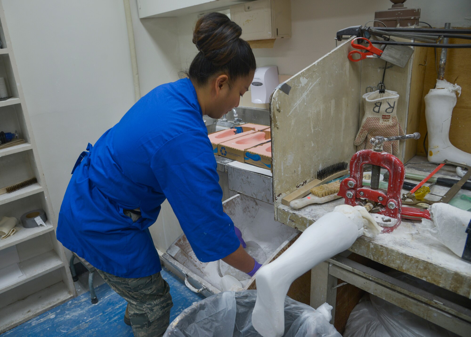 Tech. Sgt. Joy Victoria, 374th Surgical Operations Squadron orthotics NCO in charge, scoops plaster powder from a box to make a foot mold at Yokota Air Base, Japan, Jan. 20, 2016. There are only five bases in the Air Force with an Orthotics Lab, and Yokota is the sole supporter of orthotics for the Pacific Air Forces. (U.S. Air Force photo by Senior Airman David Owsianka/Released)