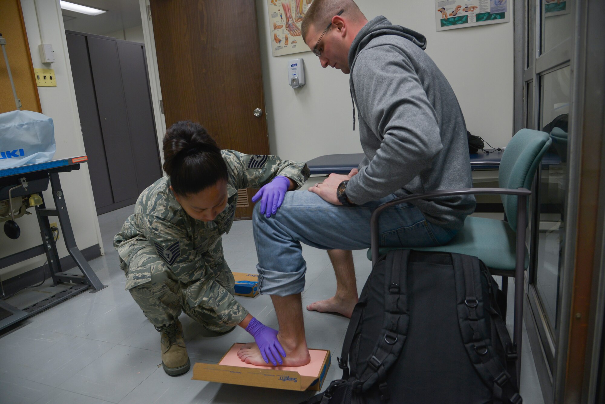 Tech. Sgt. Joy Victoria, 374th Surgical Operations Squadron orthotics NCO in charge, takes a foot impression of U.S. Navy Machinist Mate 2nd Class Michael Frazier, USS Shiloh Auxiliary division engineer, with bio foam at Yokota Air Base, Japan, Jan. 20, 2016. The clinic provides evaluations and treatment of the musculoskeletal system, to include acute fractures and dislocations, compressive neuropathies and acquired deformities. (U.S. Air Force photo by Senior Airman David Owsianka/Released)