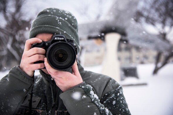 U.S. Air Force Airman 1st Class Jordyn Fetter, a photojournalist with the 35th Fighter Wing public affairs, takes a photo outside the base headquarters at Misawa Air Base, Japan, Jan. 21, 2016. Fetter’s job consists of telling Team Misawa’s stories through print and photography news and features. The U.S. Air Force engages in Public Affairs to provide trusted counsel to leaders; build, maintain, and strengthen Airman morale and readiness; enhance public trust and support; and achieve global influence and deterrence. (U.S. Air Force photo by Senior Airman Brittany A. Chase)