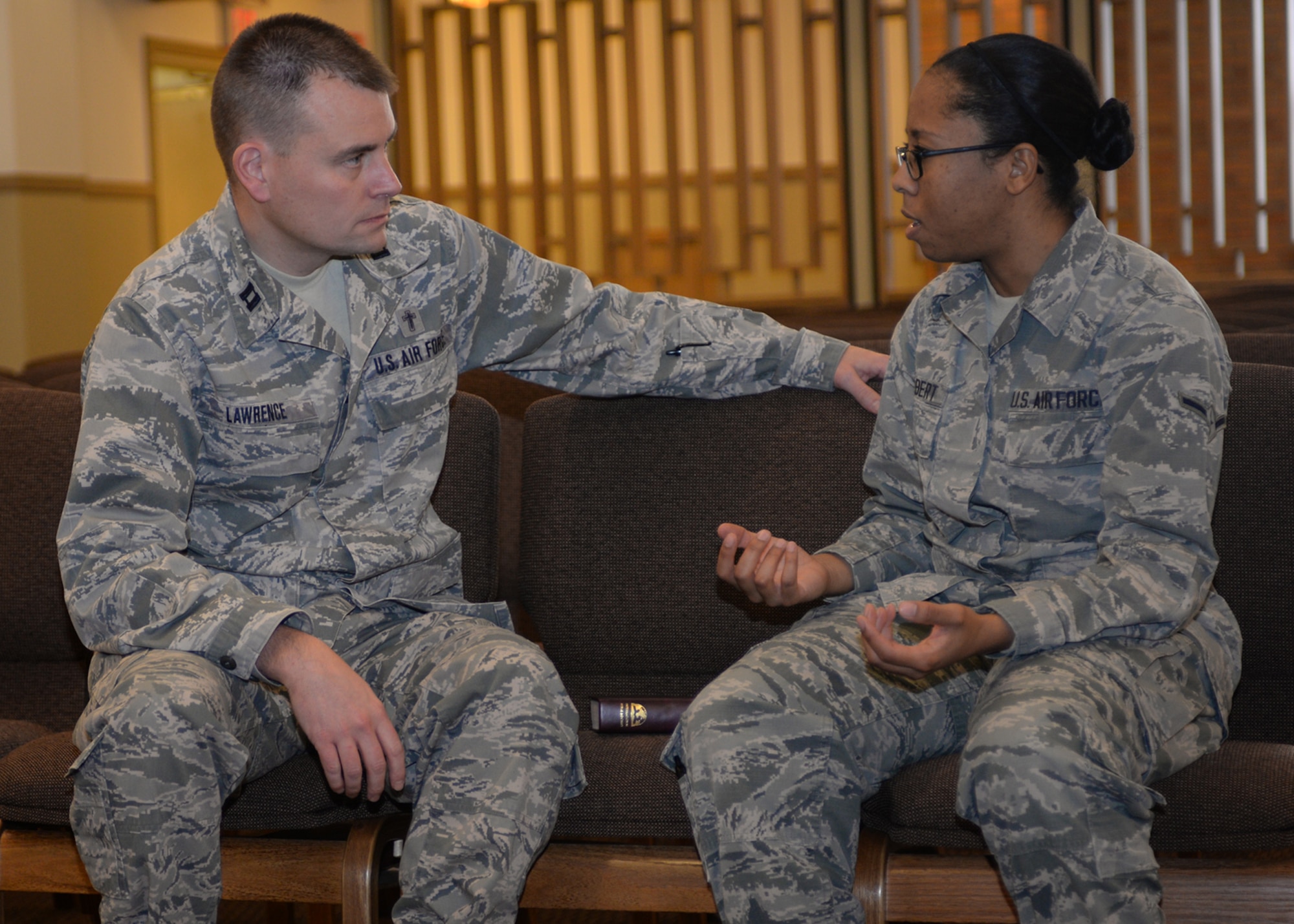 Chap. (Capt.) Greg Lawrence, 28th Bomb Wing chaplain, left, talks with Airman Sadie Colbert, 28th Bomb Wing photojournalist, at Ellsworth Air Force Base, S.D., Jan. 8, 2016. Personnel can use the chaplain corps to request confidential counseling, allowing Airmen to feel secure when discussing sensitive information. To contact the base Chapel Office, call (605) 385-1598. (U.S. Air Force photo by Airman Sadie Colbert/Released)