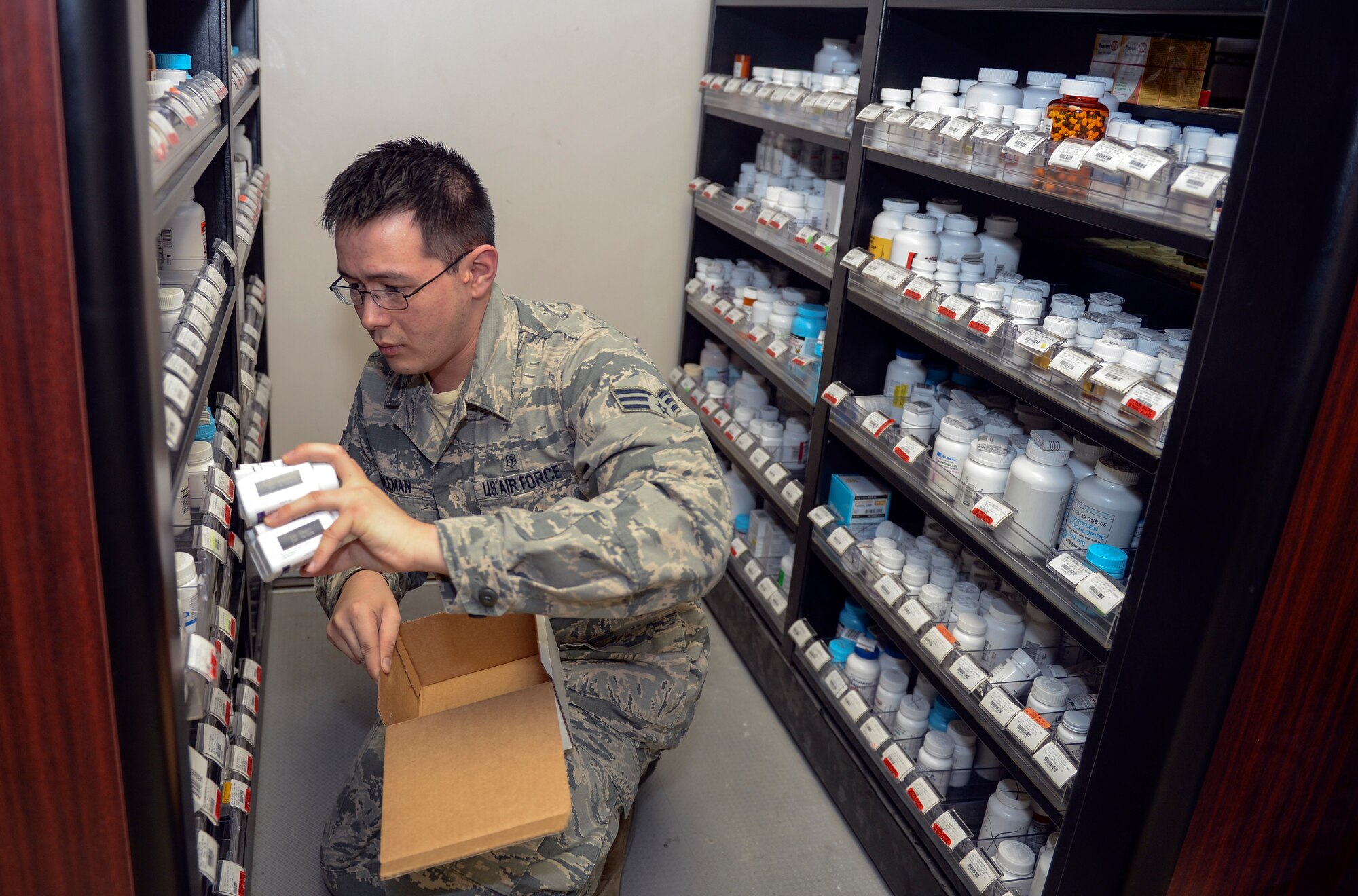 Senior Airman Bruce Coleman, 22nd Medical Support Squadron logistics warehouse technician, stocks shelves, Jan. 19, 2016, at McConnell Air Force Base, Kan. One of the duties of Airmen in the medical warehouse is to restock the medicine shelves in the base pharmacy after receiving the morning shipment, as well as keeping track of the needs of the clinic. (U.S. Air Force photo/Senior Airman Colby L. Hardin)