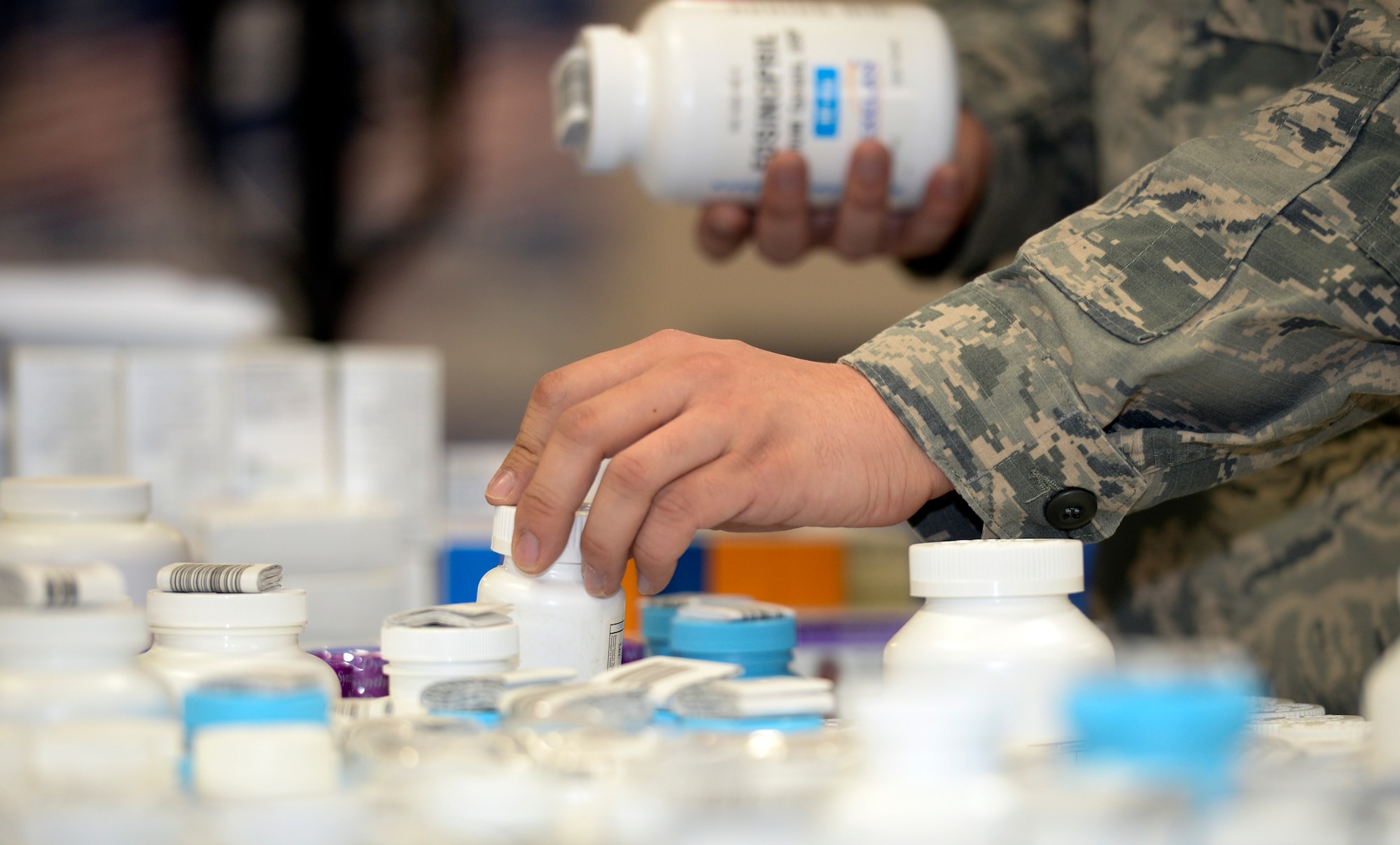 Senior Airman Bruce Coleman, 22nd Medical Support Squadron logistics warehouse technician, places a bottle of pills on a cart in the medical warehouse Jan. 19, 2016, at McConnell Air Force Base, Kan. Once the medicines are organized on the cart, they are delivered to the pharmacy for stock. (U.S. Air Force photo/Senior Airman Colby L. Hardin)