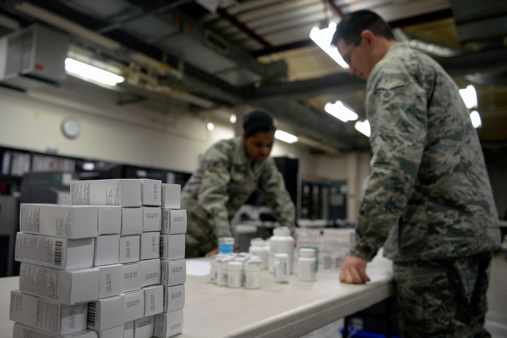 Airman 1st Class Amber Samuels and Senior Airman Bruce Coleman, 22nd Medical Support Squadron logistics warehouse technicians, review an invoice form Jan. 19, 2016, at McConnell Air Force Base, Kan. The form specifies the number of items contained in each shipment. (U.S. Air Force photo/Senior Airman Colby L. Hardin)