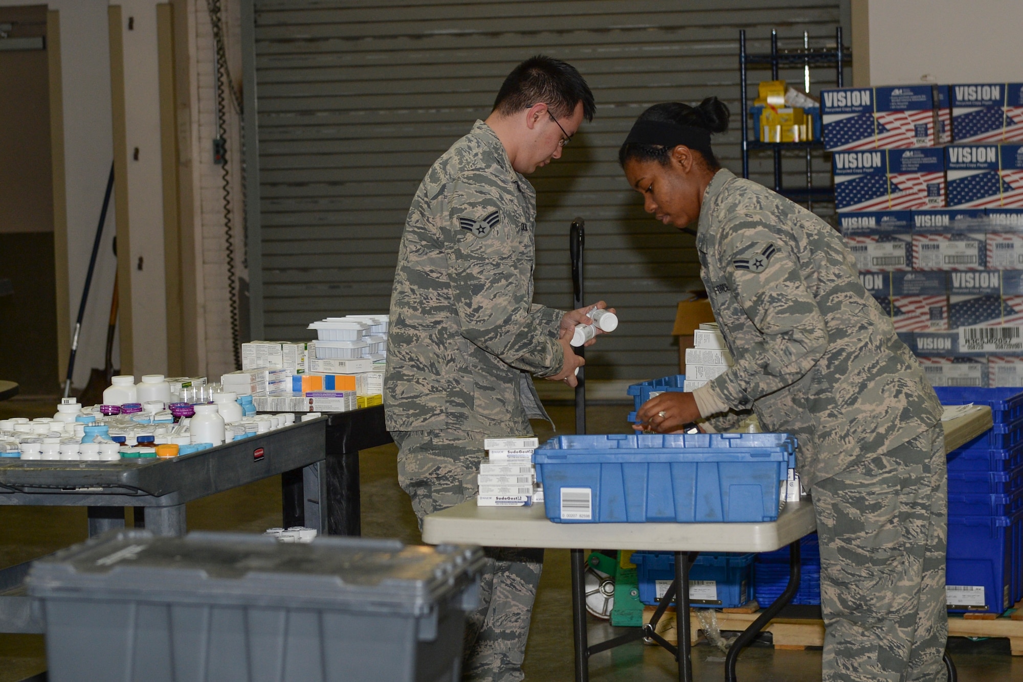 Senior Airman Bruce Coleman and Airman 1st Class Amber Samuels, 22nd Medical Support Squadron logistics warehouse technicians, verify the quantity of medicine received Jan. 19, 2016, at McConnell Air Force Base, Kan. Every morning, technicians account for a shipment of approximately $30,000 worth of medication delivered to the medical warehouse. (U.S. Air Force photo/Senior Airman Colby L. Hardin)