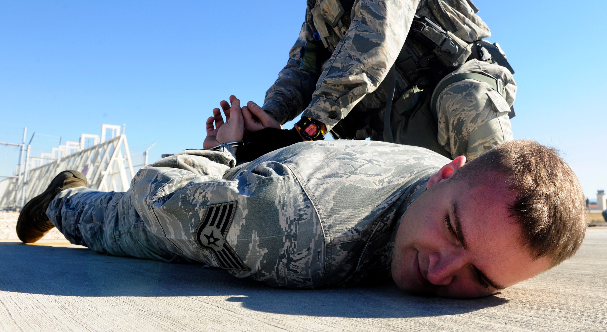 Staff Sgt. Robert Prichard, 39th Maintenance Squadron equipment maintenance technician, is searched by an Airman from the 39th Security Forces Squadron during a wing exercise Jan. 15, 2016, at Incirlik Air Base, Turkey. Prichard was apprehended while acting as a simulated insider threat during a wing exercise. (U.S. Air Force photo by Senior Airman Krystal Ardrey/Released)