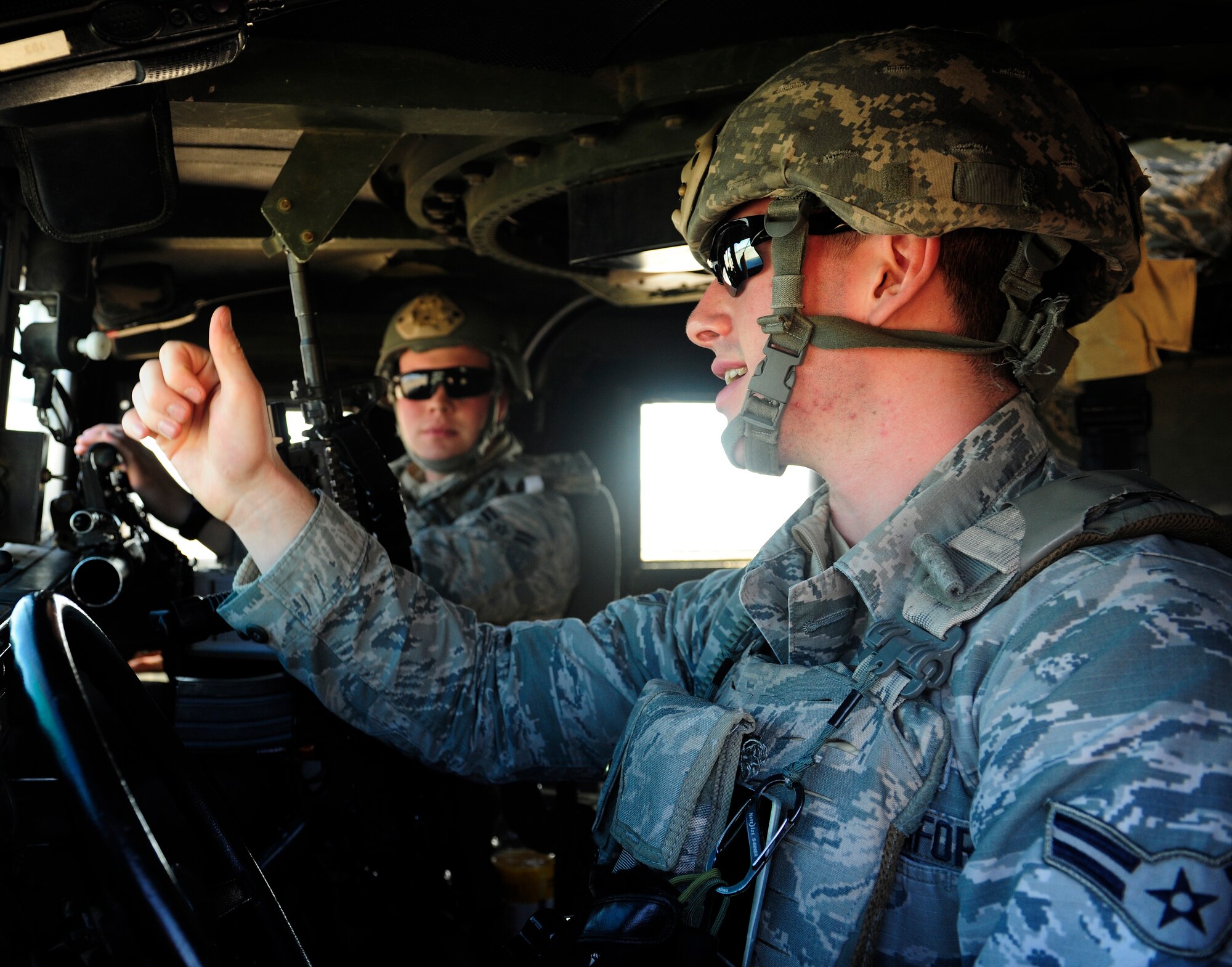 Airmen 1st Class Cody Rawson, right, and Jonathan Waggoner, 39th Security Forces Squadron security response team members, speak while participating in an exercise Jan. 15, 2016, at Incirlik Air Base, Turkey. The exercise tested security forces ability to respond to insider threats and practice convoy operations. (U.S. Air Force photo by Senior Airman Krystal Ardrey/Released)