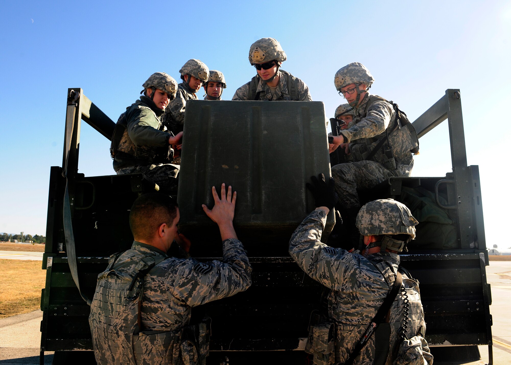 Airmen from the 39th Security Forces Squadron load gear and personnel into the back of a truck after participating in a wing exercise Jan. 15, 2016, at Incirlik Air Base, Turkey. The gear was used as part of a wing exercise in which security forces practiced security measure techniques on simulated threats. (U.S. Air Force photo by Senior Airman Krystal Ardrey/Released)