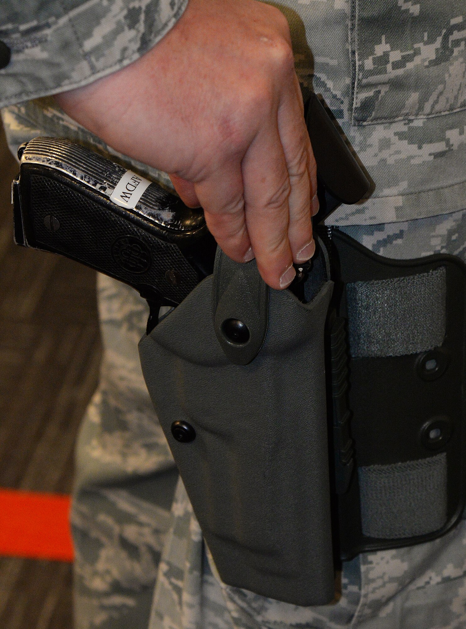 Master Sgt. Chris Romano, Air Force District of Washington Security Forces Plans and Programs Branch superintendent, is armed with an M9 service pistol at the William A. Jones III building on Joint Base Andrews, Md., Dec. 30, 2015. Staff arming allows AFDW personnel with a Security Forces background to be armed in the building while working in a staff position to prevent active shooter threats. (U.S. Air Force photo/1st Lt. Esther Willett)