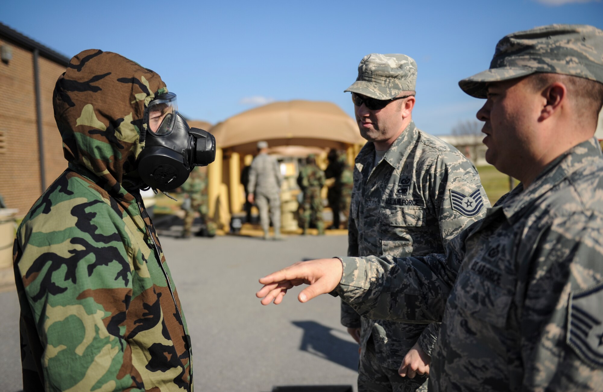 U.S. Air Force Master Sgt. Christopher Whitehouse, 19th Operations Support Squadron aircrew flight equipment quality assurance noncommissioned officer in charge, right, questions an Airman on contamination control procedures Jan. 14, 2016, at Little Rock Air Force Base, Ark. Aircrew flight equipment specialists practice aircrew contamination control procedures monthly to ensure prompt response to any chemical, biological, radiological or nuclear threats. (U.S. Air Force photo/ Senior Airman Harry Brexel) 