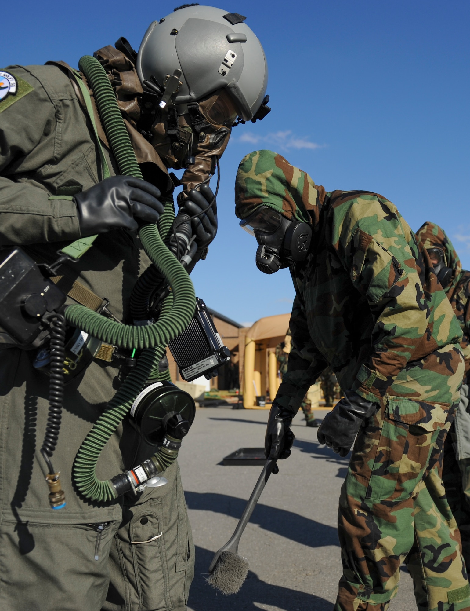 U.S. Air Force Airman 1st Class Benjamin Ammann, 19th Operations Support Squadron aircrew flight equipment journeyman, scrubs a C-130J loadmaster’s boots, as part of an aircrew contamination control area exercise Jan. 14, 2016, at Little Rock Air Force Base, Ark. Aircrew members must go through nine different decontamination stations after any exposure to chemical, biological, radiological or nuclear threats. (U.S. Air Force photo/ Senior Airman Harry Brexel) 