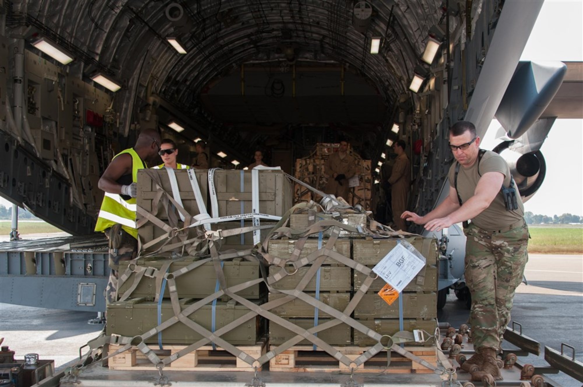 Airmen from the 621st Contingency Response Wing work alongside French and Gabonese forces to load cargo onto a C-17 Globemaster III in Libreville, Gabon, Dec. 15, 2015. The result was the timely deployment of more than 450,000 pounds of vital equipment and vehicles to assist the Gabonese military's mission supporting the United Nations Multidimensional Integrated Stabilization Mission in the Central African Republic, or MINUSCA. (Photo courtesy of French military, ADC Laminette)