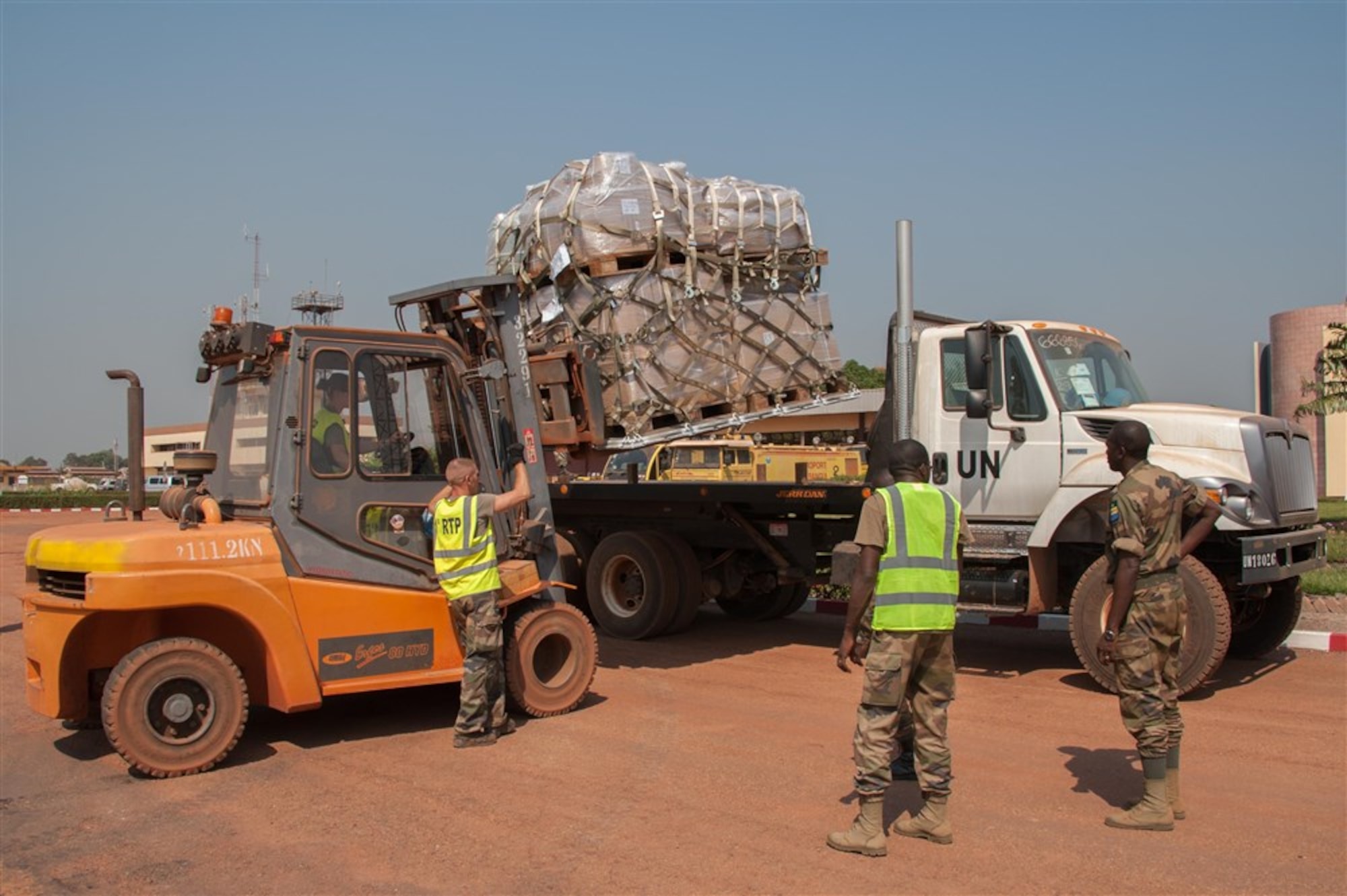Airmen from the 621st Contingency Response Wing work alongside French and Gabonese forces to load cargo bound for Bangui, Central African Republic, Dec. 15, 2015. The result was the timely deployment of more than 450,000 pounds of vital equipment and vehicles to assist the Gabonese military's mission supporting the United Nations Multidimensional Integrated Stabilization Mission in the Central African Republic, or MINUSCA. (Photo courtesy of French military, ADC Laminette)