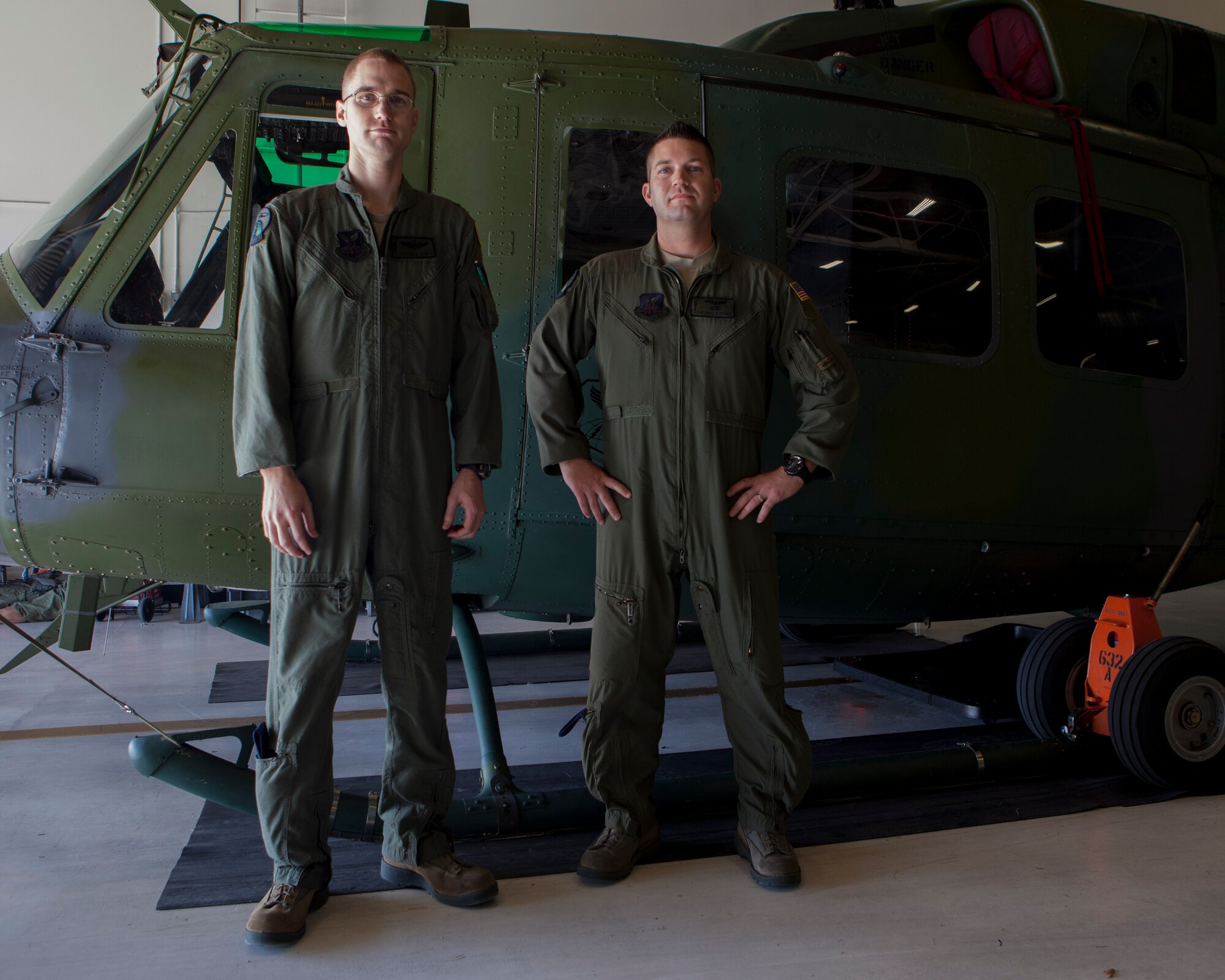 Capt. Stephen Jones, 37th Helicoptor Squadron command pilot and Staff Sgt. Brice Marshall, 37th HS flight engineer, pose with a UH-1N Huey helicopter on F.E. Warren Air Force Base, Wyo., Jan. 20, 2016. Jones and Marshall were part of a search and rescue mission that saved two lives on Jan. 18. (U.S. Air Force photo by Lan Kim)