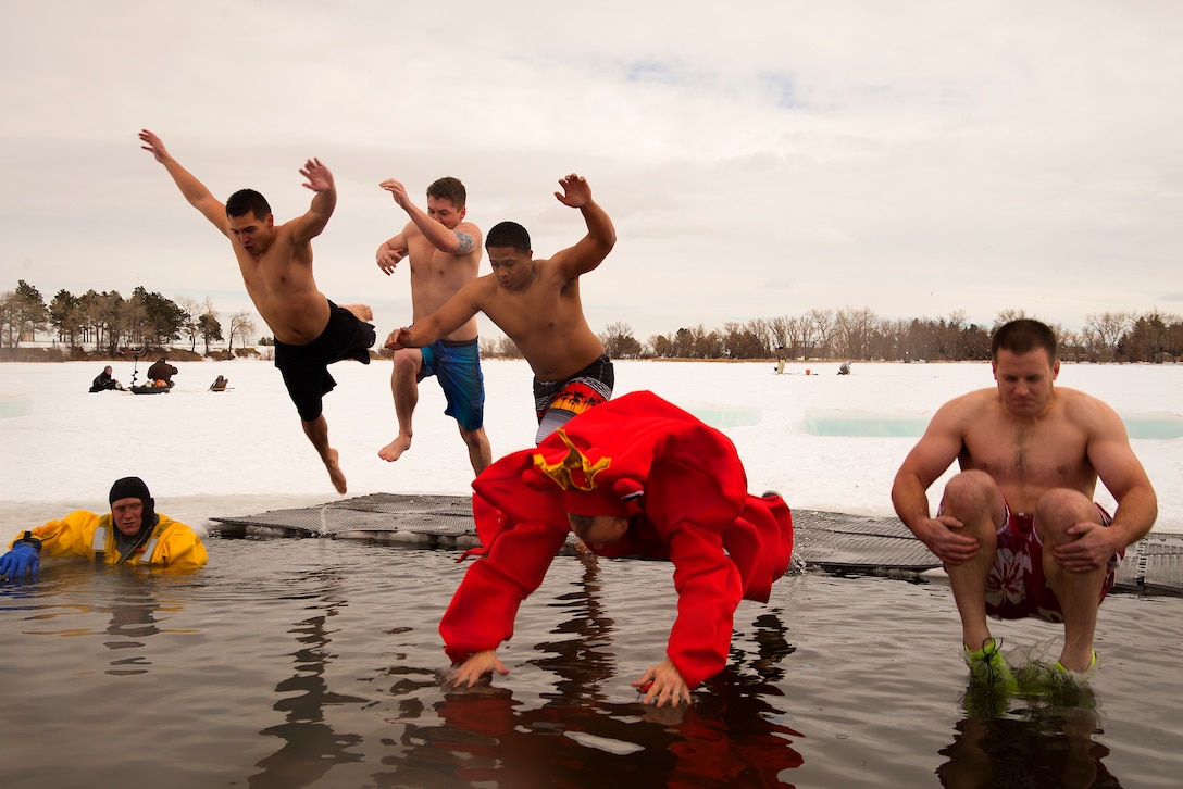 Airman 1st Class Damian Dimmick, 90th Missile Security Forces Squadron; Brook Preren; Senior Airman Andy Vargas Noesi, 90th MSFS; Robert Randall and Zack Johnson each find their own style as they jump into Sloan Lake in Cheyenne, Wyo., January 16, 2016. They had each paid $20 for the privilege of a swim in 34-degree water as part of the Matthew S. Schwartz Memorial Polar Plunge named for an Explosive Ordinance Disposal technician assigned to F.E. Warren Air Force Base who was killed in action while deployed to Afghanistan in 2012. (U.S. Air Force photo by R.J. Oriez)